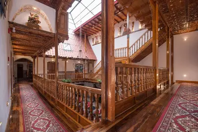 a large room with wooden stairs and a balcony at Casona Corrales Hotel Boutique in Cusco