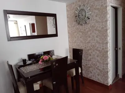 a dining room with a table and a mirror at Hope San Isidro in Lima
