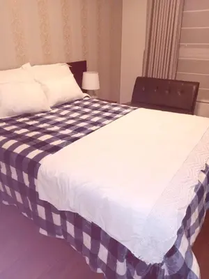 a large bed with a blue and white blanket on it at Hope San Isidro in Lima