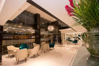 a lobby with chairs and a vase of flowers at Hotel Britania Crystal Collection in Lima