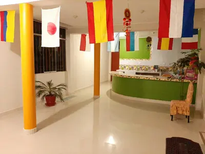 a room with colorful flags hanging from the ceilings at Marlon's House Nasca in Nazca