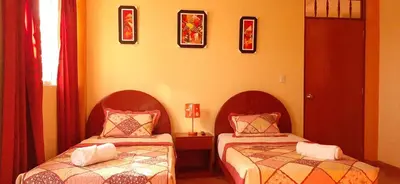 a bedroom with two beds and a window at Marlon's House Nasca in Nazca