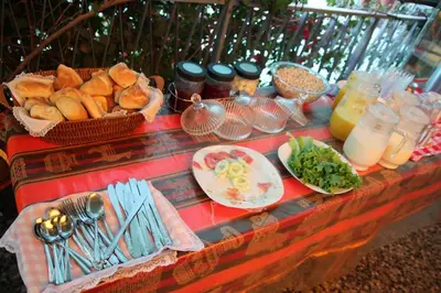 a table topped with plates of food and drinks at Marlon's House Nasca in Nazca
