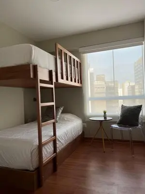 a bedroom with two bunk beds and a window at MLA Apartments - Alcanfores in Lima