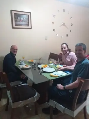 a group of three people sitting around a table at Chakana Family Home Lima Airport in Lima