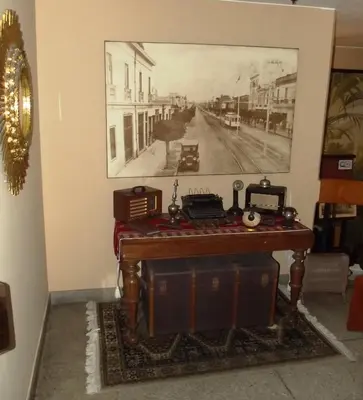a room with a desk with a picture on the wall at Hostal Gemina in Lima