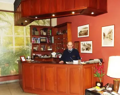 a man sitting at a bar in a room at Hostal Gemina in Lima