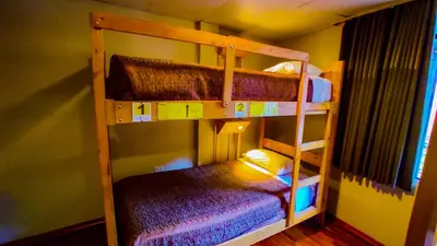 a bunk bed room with two bunk beds in a room at Nativus Hostel Machu Picchu in Machu Picchu