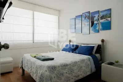 a bedroom with a bed with blue sheets and a window at Pet Friendly Apart-Maximo 9 Personas-Piscina-Parrilla-Billar-Gimnasio in Lima
