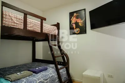 a bedroom with two bunk beds and a flat screen tv at Pet Friendly Apart-Maximo 9 Personas-Piscina-Parrilla-Billar-Gimnasio in Lima
