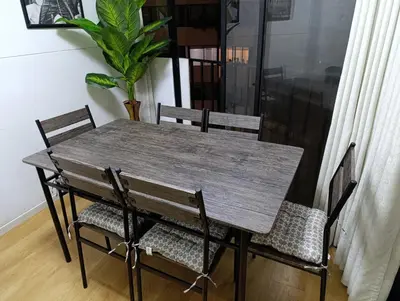 a wooden table with two chairs and a potted plant at Pet Friendly Apart-Maximo 9 Personas-Piscina-Parrilla-Billar-Gimnasio in Lima