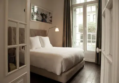 a hotel room with a bed and a window at Hotel B in Lima