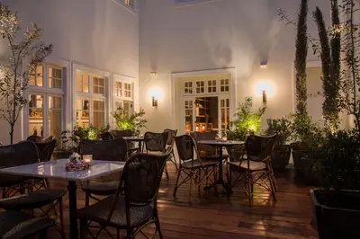 a patio with tables and chairs in a restaurant at Hotel B in Lima