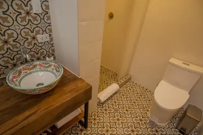 a bathroom with a toilet and a sink at Casa Biru Hotel Boutique in Cusco