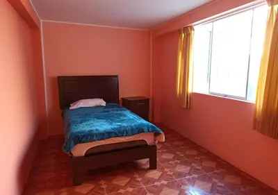 a small bedroom with a bed and a window at La Azotea in Huancayo