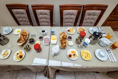 a table with plates of food on it at Hostal El Peregrino in Cusco