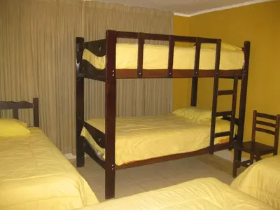 a bunk bed room with two bunk beds at Posada Gino in Pisco