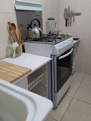 a kitchen with a stove and a sink at MUNAYCHA`S WASI in Cusco
