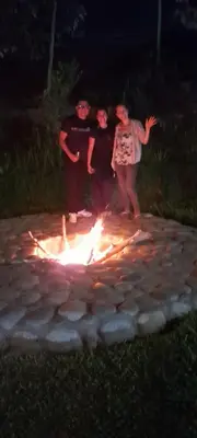 a group of people standing around a fire at Hotel Quilla Wasi in Lunahuaná