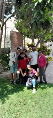 a group of people posing for a picture under a tree at Hotel Quilla Wasi in Lunahuaná