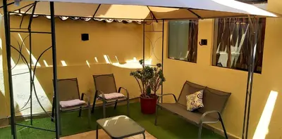 a room with chairs and a table and a tent at wayra house san blas in Cusco