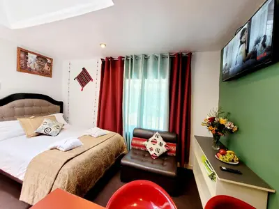 a bedroom with a bed and a chair in a room at wayra house san blas in Cusco