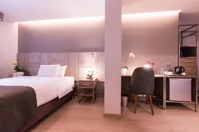 a bedroom with a bed and a desk and a chair at Surya Lima in Lima