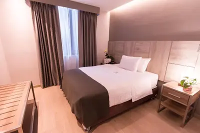 a hotel room with a large bed and a window at Surya Lima in Lima