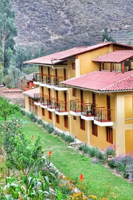 a building with balconies on the side of it at Tunupa Lodge Hotel in Ollantaytambo
