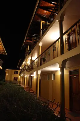 a building with lights on the side of it at night at Tunupa Lodge Hotel in Ollantaytambo