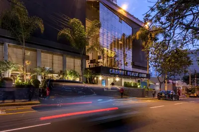 a van driving down a street in front of a building at Crowne Plaza Lima by IHG in Lima