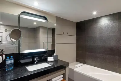 a bathroom with a sink and a tub and a mirror at Crowne Plaza Lima by IHG in Lima
