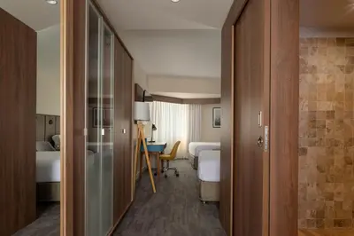 a hotel room with a bedroom with a bed and a desk at Crowne Plaza Lima by IHG in Lima