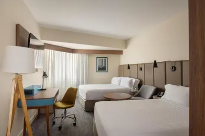 a hotel room with two beds and a desk at Crowne Plaza Lima by IHG in Lima