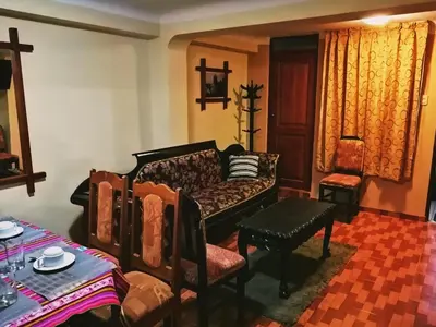 a living room with a couch and a table at Conquista Cusco in Cusco