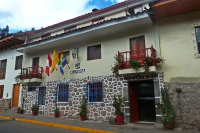 a building with flags and plants in front of it at Conquista Cusco in Cusco