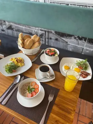 a table with plates of food on a table with drinks at Lima 18 Boutique in Lima