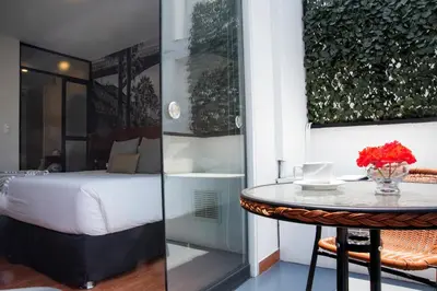 a hotel room with a bed and a table with a table at Lima 18 Boutique in Lima