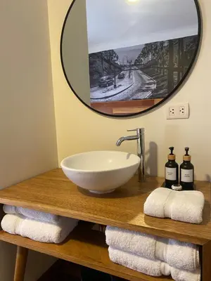 a bathroom with a sink and a mirror and towels at Lima 18 Boutique in Lima