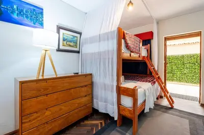 a childs bedroom with a bunk bed and a dresser at Británico en Miraflores & primer piso, 3 dormitorios in Lima