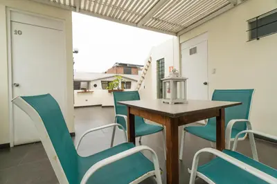 a dining room with a table and chairs at B&B Wasi Airport Lima in Lima