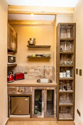 a kitchen with a sink and some shelves at NUNA by DCO in Urubamba