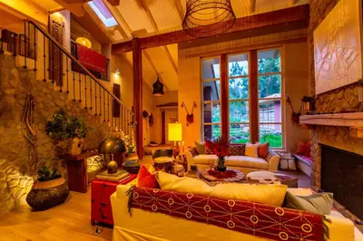 a living room with a couch and a fireplace at NUNA by DCO in Urubamba