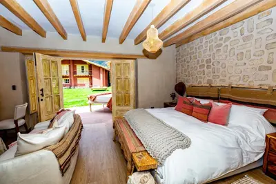 a bedroom with a bed and a couch in a room at NUNA by DCO in Urubamba