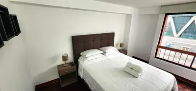 a bedroom with a large bed and a window at Hermoso departamento en el Corazón de Miraflores in Lima