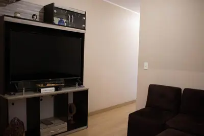 a living room with a large flat screen tv at Departamento 100 m2 con luz natural y Seguridad 24h in Lima