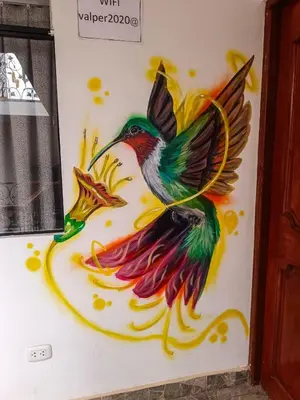 a painting of a hummingbird on a wall at Casa ValPer in Cusco