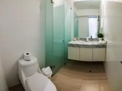 a bathroom with a white toilet and a sink at Departamento de playa - Condominio OCEAN REEF - SAN BARTOLO in San Bartolo