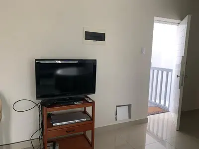 a flat screen tv sitting on top of a wooden stand at DEPARTAMENTO SAN BARTOLO-2dormitorios in Lima