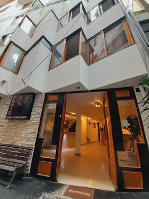 a building with a building with windows and a staircase at Fenix Hotel Machupicchu in Machu Picchu